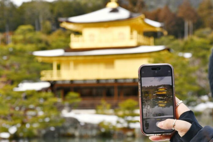 a person taking a picture of a building with a cell phone
