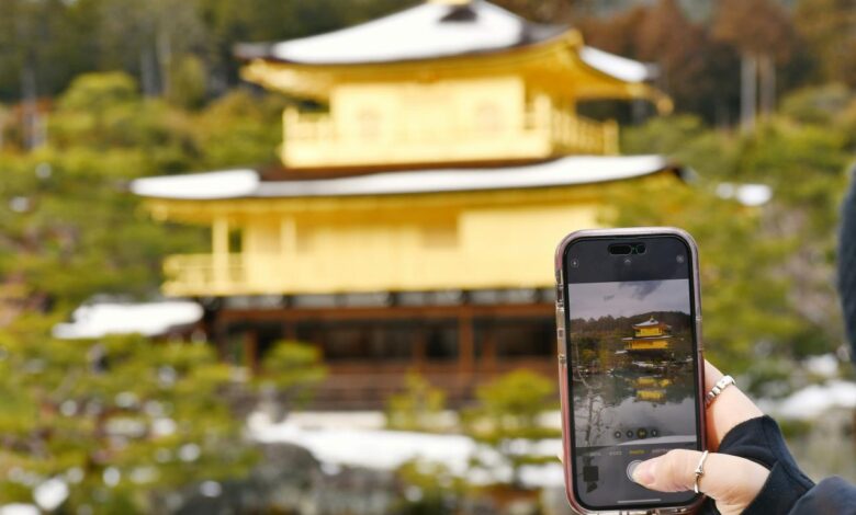 a person taking a picture of a building with a cell phone