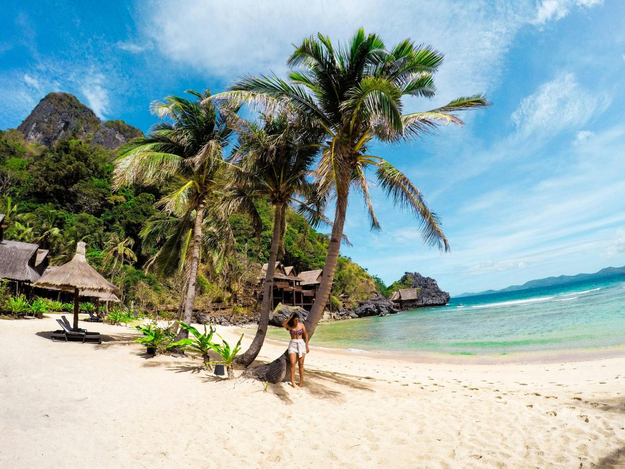 woman in black bikini walking on beach during daytime